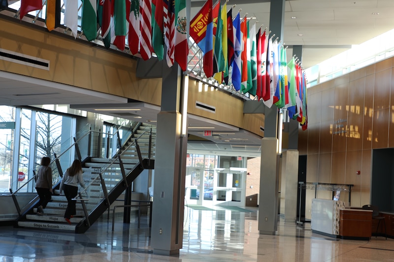 Two people walk up a staircase at Ivy Tech