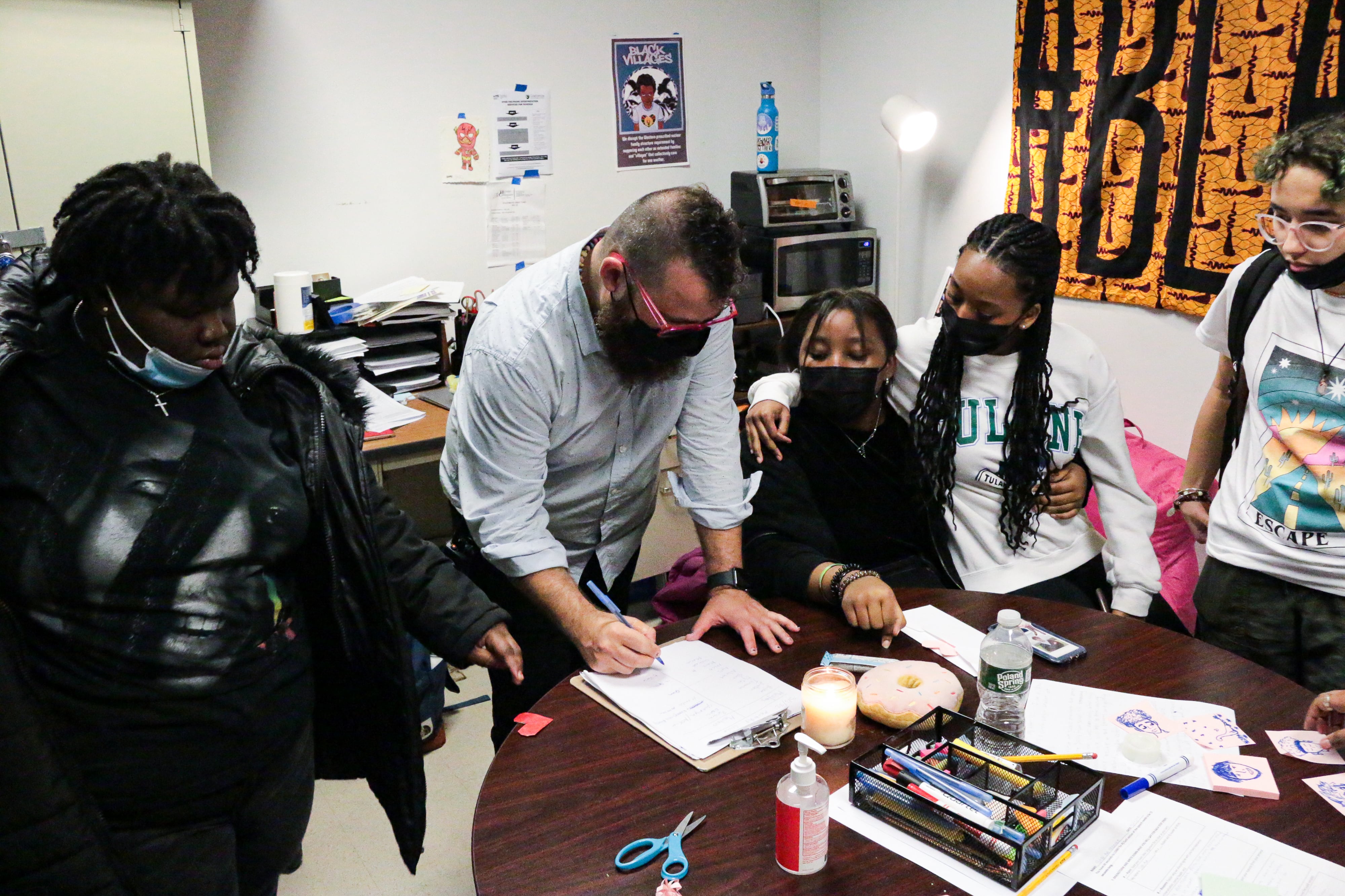 A teacher guides his students through a restorative circle in class.